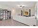 Spacious living room with a comfortable white sofa, ceiling fan, and decorative shelving at 1100 Downswing Pl, Davenport, FL 33896