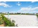 Community volleyball court, perfect for outdoor recreation, with sand and green poles at 1100 Downswing Pl, Davenport, FL 33896