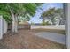 Large backyard with a concrete pad, mature trees, and a white privacy fence at 1102 Brielle Ct, Oviedo, FL 32765