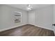 Clean bedroom with a bright window, neutral walls, hardwood flooring, and a spacious double door closet at 1102 Brielle Ct, Oviedo, FL 32765