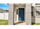 Stylish front entrance with a blue door and decorative pillars at 1102 Brielle Ct, Oviedo, FL 32765