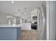 Kitchen with an island, stainless steel refrigerator, and modern lighting at 1102 Brielle Ct, Oviedo, FL 32765