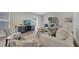 Cozy living room with comfortable seating, a large window, stylish furniture, and modern decor at 1102 Brielle Ct, Oviedo, FL 32765