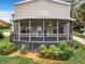 Back of home with a spacious screened-in porch, perfect for outdoor entertaining and relaxation at 1155 Orange Grove Ln, Apopka, FL 32712