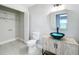 Modern bathroom featuring a unique vessel sink, toilet, and closet with shelving at 1155 Orange Grove Ln, Apopka, FL 32712