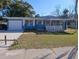 Charming single-story home featuring a cozy, covered front porch at 1403 Hialeah Dr, Orlando, FL 32808