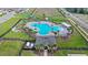 Aerial view of the community pool, surrounding greenery and clubhouse at 1443 Lassen St, Haines City, FL 33844