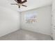 Bright, neutral bedroom with tile flooring and a ceiling fan at 1443 Lassen St, Haines City, FL 33844