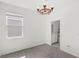 Bright bedroom showcasing carpeted floors, a window, and a doorway to a bathroom at 1443 Lassen St, Haines City, FL 33844