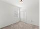 Neutral bedroom featuring carpeted floors, a window, and a closet with double doors at 1443 Lassen St, Haines City, FL 33844