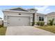 Beautiful home boasting a two-car garage and tidy landscaping at 1443 Lassen St, Haines City, FL 33844