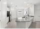 Modern kitchen featuring white cabinets, gray countertops, and stainless steel appliances at 1443 Lassen St, Haines City, FL 33844
