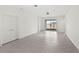 Bright, neutral living space with tile floors, featuring sliding doors to the backyard at 1443 Lassen St, Haines City, FL 33844