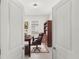 Open doorway featuring a view of an office with a desk, chair, and a bookshelf at 1443 Lassen St, Haines City, FL 33844