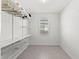 Spacious walk-in closet with custom shelving, hanging racks, drawers, and a window at 1443 Lassen St, Haines City, FL 33844