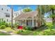 Charming home featuring a quaint front porch and vibrant red stairs nestled in a lush green yard at 204 Park Lake St, Orlando, FL 32803