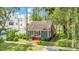 Charming home featuring a quaint front porch and vibrant red stairs nestled in a lush green yard at 204 Park Lake St, Orlando, FL 32803