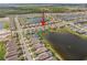 Elevated view showcasing a community nestled amongst serene lakes and lush greenery at 211 Venetian Palms Blvd, New Smyrna Beach, FL 32168