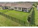 Aerial view of the fenced backyard with lush grass, perfect for outdoor enjoyment at 211 Venetian Palms Blvd, New Smyrna Beach, FL 32168