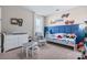 Bright, well-decorated bedroom with a blue accent wall and plenty of natural light at 211 Venetian Palms Blvd, New Smyrna Beach, FL 32168