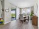 Cozy dining room with chandelier lighting, neutral decor, and sliding glass doors to an outdoor patio at 211 Venetian Palms Blvd, New Smyrna Beach, FL 32168