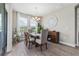 Charming dining area with hardwood floors, chandelier, and sunlit windows overlooking scenic backyard views at 211 Venetian Palms Blvd, New Smyrna Beach, FL 32168