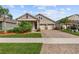 Charming single-Gathering home featuring a two-car garage, manicured lawn and beautiful landscaping at 211 Venetian Palms Blvd, New Smyrna Beach, FL 32168