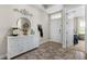 Elegant foyer featuring a decorative console table, decorative mirror, and beautiful flooring at 211 Venetian Palms Blvd, New Smyrna Beach, FL 32168