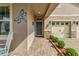 Charming front entrance with a covered porch, stone accents, and beautiful landscaping at 211 Venetian Palms Blvd, New Smyrna Beach, FL 32168