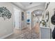 Hallway view showcasing a decorative console table, artwork, and seamless transition between rooms at 211 Venetian Palms Blvd, New Smyrna Beach, FL 32168