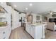 Open kitchen with island, granite countertops, stainless appliances, and seamless flow into the living area at 211 Venetian Palms Blvd, New Smyrna Beach, FL 32168