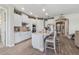 Bright kitchen boasts white cabinetry, island seating, stainless appliances, and open layout for entertaining at 211 Venetian Palms Blvd, New Smyrna Beach, FL 32168