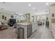 Spacious open-concept layout showcasing kitchen island, living, and dining areas with modern finishes at 211 Venetian Palms Blvd, New Smyrna Beach, FL 32168