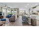 Open-concept living room with large windows, tile flooring, and a view of the dining area at 211 Venetian Palms Blvd, New Smyrna Beach, FL 32168