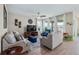 Comfortable living room featuring large windows, ample seating, and stylish decor at 211 Venetian Palms Blvd, New Smyrna Beach, FL 32168