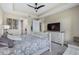 Spacious main bedroom with tray ceiling, decorative bed frame, carpeted floors, and a large television at 211 Venetian Palms Blvd, New Smyrna Beach, FL 32168