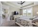 Bright main bedroom features a large window overlooking the water, neutral walls, and a decorative bed frame at 211 Venetian Palms Blvd, New Smyrna Beach, FL 32168