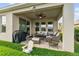 Cozy covered patio featuring comfortable seating and a ceiling fan at 211 Venetian Palms Blvd, New Smyrna Beach, FL 32168