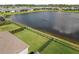 Aerial view of the backyard with a serene pond, enhancing the property's appeal at 211 Venetian Palms Blvd, New Smyrna Beach, FL 32168