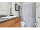 Bathroom featuring a sleek vanity, a functional toilet, and a shower-tub combination with a gray shower curtain at 224 Lewfield Cir, Winter Park, FL 32792