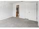 Bedroom featuring neutral carpet, closet, and a partial view of the bathroom at 224 Lewfield Cir, Winter Park, FL 32792