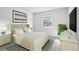Serene bedroom featuring crisp white bedding, soft lamps, a large window, and stylish furnishings at 224 Lewfield Cir, Winter Park, FL 32792