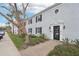 Charming two-story condo featuring well-maintained landscaping and a classic brick walkway leading to the front door at 224 Lewfield Cir, Winter Park, FL 32792