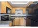 The kitchen featuring stainless steel appliances and ample cabinet space at 224 Lewfield Cir, Winter Park, FL 32792