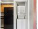 Convenient in-unit laundry closet featuring a stacked washer and dryer at 224 Lewfield Cir, Winter Park, FL 32792