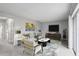Bright living room with neutral walls, plush carpet, stylish furniture, and a large sliding glass door at 224 Lewfield Cir, Winter Park, FL 32792