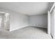 Spacious living room with neutral carpet, light gray walls, and sliding glass doors at 224 Lewfield Cir, Winter Park, FL 32792