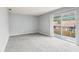 Bright living room with neutral carpet and sliding doors leading to a balcony at 224 Lewfield Cir, Winter Park, FL 32792