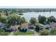 Aerial view showcases a home with a spacious yard, mature trees, and proximity to a serene lake community at 2743 Grandola Dr, Orlando, FL 32811