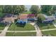 Stunning aerial view of a home showcasing lush greenery, a red roof, and a tranquil lake in the backdrop at 2743 Grandola Dr, Orlando, FL 32811